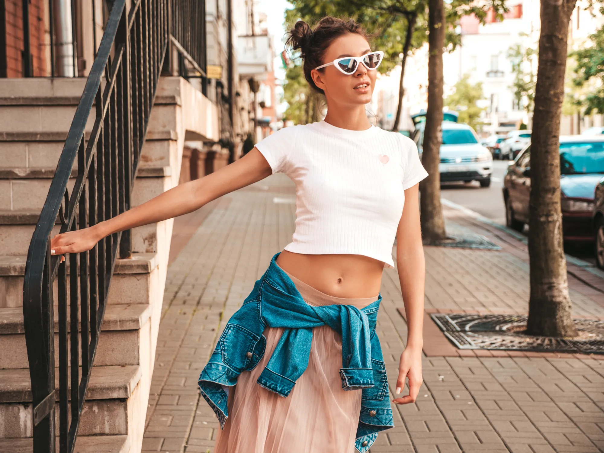 Beautiful smiling model with horns hairstyle dressed summer hipster jacket jeans clothes sexy carefree girl posing street trendy funny positive woman having fun sunglasses